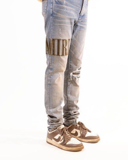 AMIRI LOGO-EMBROIDERED RIPPED-DETAIL JEANS