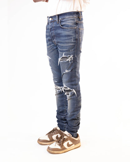 AMIRI MX1 SKINNY-FIT PANELLED DISTRESSED JEANS